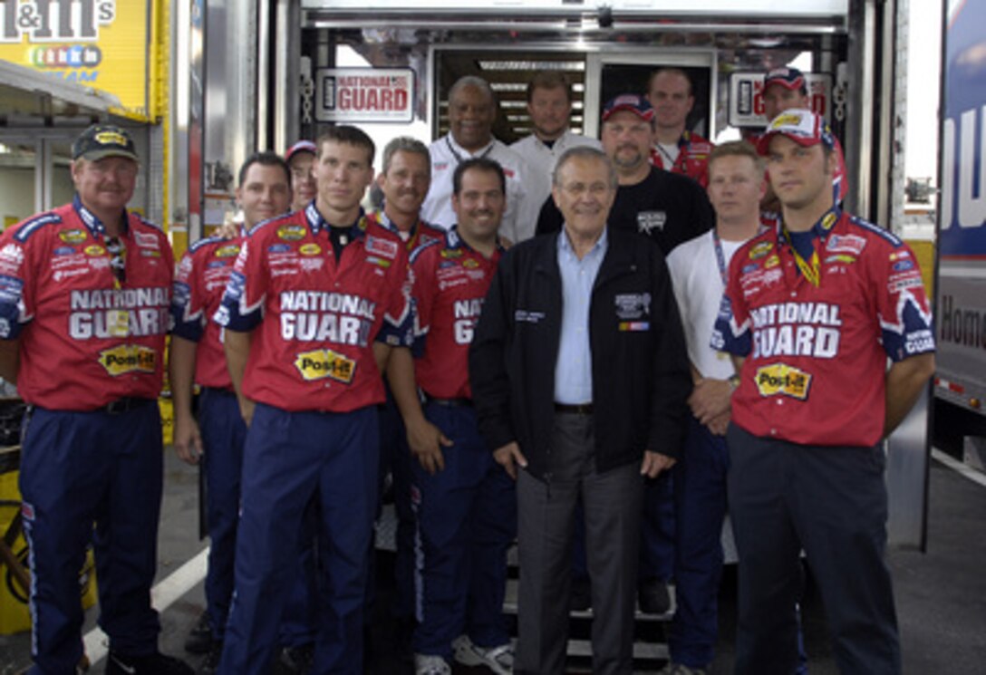 Secretary of Defense Donald H. Rumsfeld poses for a group photo with the Roush Racing National Guard team before the start of the Pepsi 400 at Daytona International Speedway, Fla., on July 2, 2005. Rumsfeld met with NASCAR fans, drivers and their pit crews as he toured the infield before the race. Rumsfeld served as the as the Grand Marshal of the 47th running of the Pepsi 400 and gave the command "Gentlemen, start your engines". 