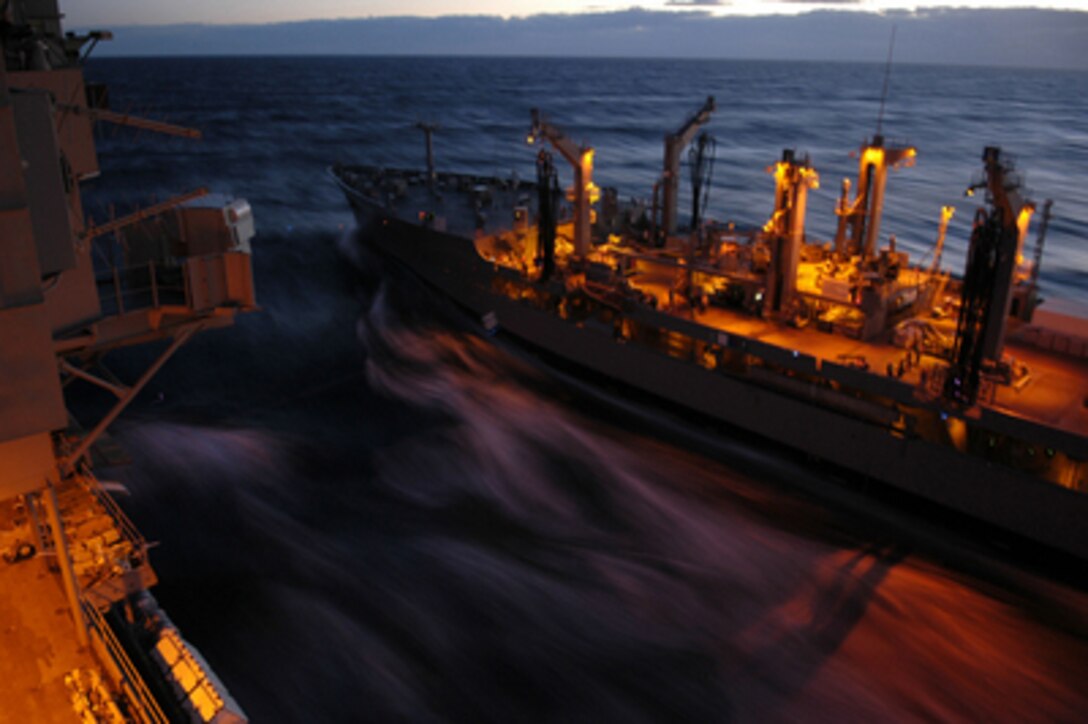 The underway replenishment oiler USNS Guadalupe (T-AO 200) pulls alongside the aircraft carrier USS Kitty Hawk (CV 63) during a replenishment at sea operation on July 2, 2005. The underway replenishment allows fuel for both ships and aircraft, and stores to be transferred from ship-to-ship, extending their at sea capabilities. The Kitty Hawk Carrier Strike Group recently completed combined exercise Talisman Saber with the Australian Navy. 