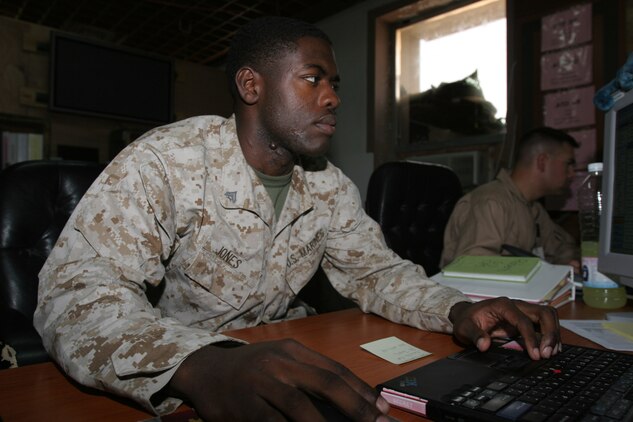 AL ASAD, Iraq ? Corporal Allen Jones, the air tasking order production chief with Marine Wing Headquarters Squadron 2 organizes the air tasking order before another day of flight operations is finalized. Jones earned a scholarship to play football after high school, but broke his collar bone during his senior year at Austin High School in Decatur, Ala.