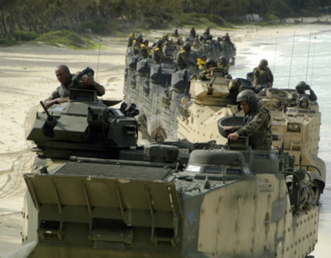 A convoy of Marine Amphibious Assault Vehicles snakes down the beach on Kauai, Hawaii, as the Marines prepare to return to the USS Peleliu (LHA 5) after combat training exercises on June 27, 2005. The Marines from the 3rd Amphibious Assault Battalion are conducting amphibious training on the beaches of the Pacific Missile Range Facility on Kauai. 