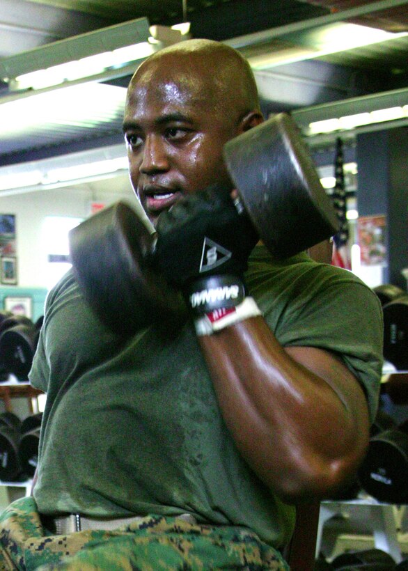 Staff Sgt. Lenwood L. Hall, 6th Marine Corps District comptroller chief, curls 115 pounds at the Parris Island War Memorial gym Tuesday.
