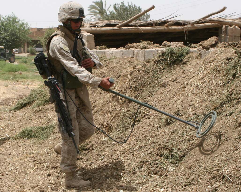 Corporal Khanh Pham, 23, combat engineer, CLB-8, 2nd Force Service Support Group (forward), conducts a weapons cache sweep in the Zaidon Village area in support of Operation Scimitar. Pham, who is attached to Echo Company, Iraqi Interdiction Force Platoon, 3rd Reconnaissance Battalion, 2nd Marine Division, supports the battalion with improvised explosive device, mine and weapon cache sweeps.