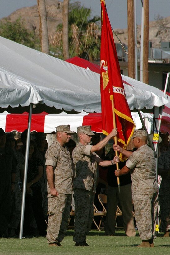 Sgt. Maj. Manuel Garibay Jr., station sergeant major, passes the station battle colors from Col. James J. Cooney, outgoing station commanding officer, to Col. Ben D. Hancock, incoming station CO. The transfer of unit colors signifies the passing of responsibility, authority, accountability and command from one Marine to another.