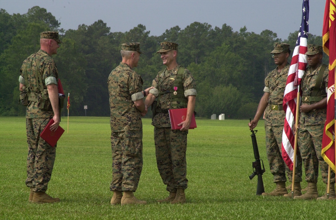 CAMP GEIGER, N.C. - Lieutenant Gen. James F. Amos, commanding general, II Marine Expeditionary Force, shakes hands with Col. Bradford Washabaugh, commanding officers, School of Infantry (East), during his retirement ceremony July 8. Washabaugh's awards and decorations include the Legion of Merit, the Bronze Star Medal, the Defense Meritorious Service Medal, the Meritorious Service Medal, the Navy and Marine Corps Commendation Medal and the Navy/Marine Corps Parachutist Insignia. He, his wife, Linda, and their two children, Brooke and Brandon, are currently in transit to Raleigh, N.C., where Washabaugh will begin his civilian career.