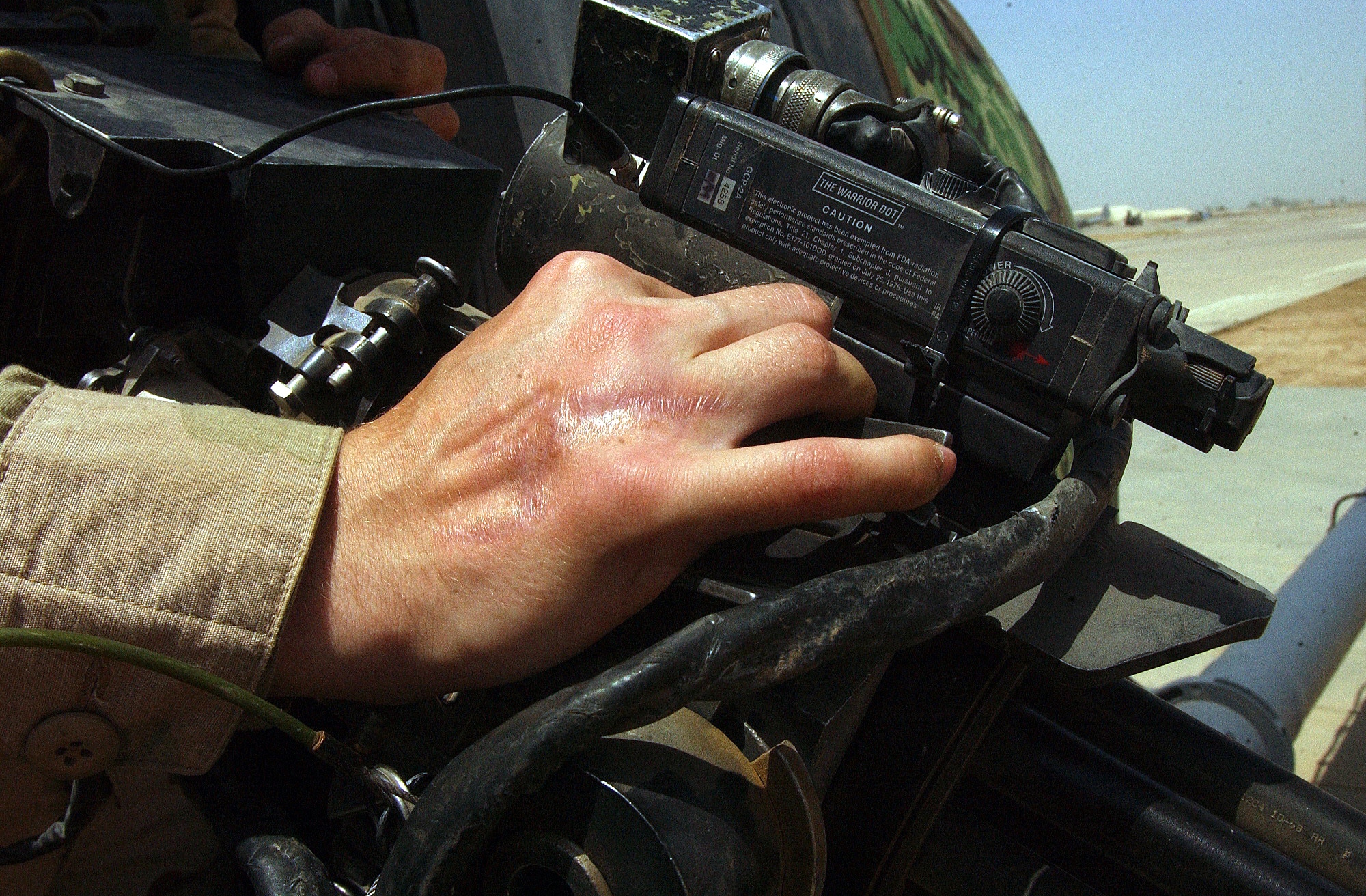 BALAD AIR BASE, Iraq -- In 2003, Senior Airman Douglas Batchelder suffered numerous injuries from flying shrapnel when a rocket careened off his back and exploded in his tent in Baghdad.  After five hand surgeries, he is back in Iraq with the 64th Helicopter Maintenance Unit here.  (U.S. Air Force photo by Senior Airman Tim Beckham)         