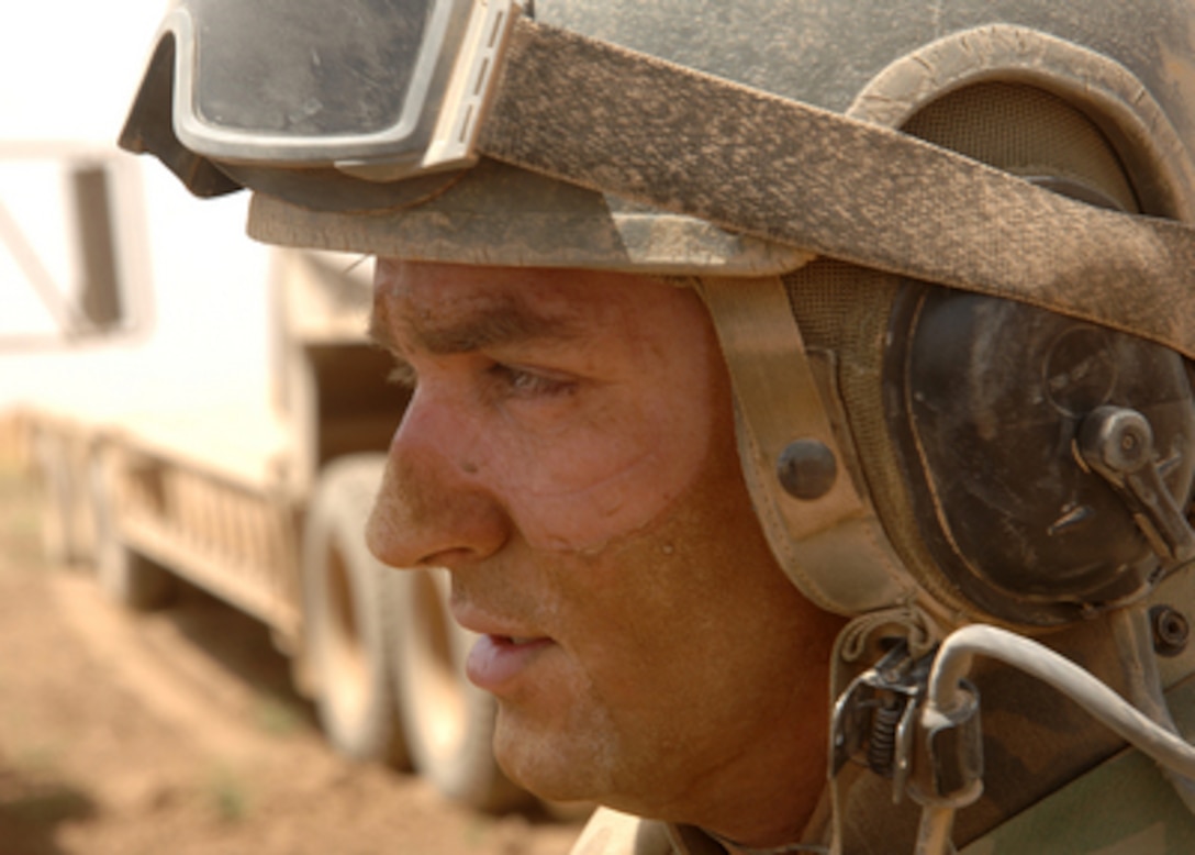 Army Sgt. Jonathon Clark takes a break after a long day of operating an Armored Combat Earth mover used to reinforce the berm separating Iraq and Syria in Iraq's Ninewa province on June 29, 2005. Clark is a member of the 43rd Combat Engineering Company which is attached to the 3rd Armored Cavalry Regiment. 