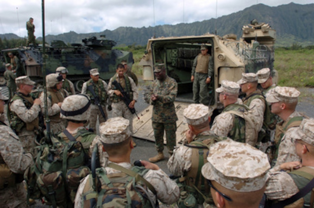 Marine Capt. Benjamin Venning (center) talks to his Marines after they finished training with their amphibious assault vehicles in Kauai, Hawaii, on June 27, 2005. The Marines from the 3rd Amphibious Assault Battalion are conducting amphibious training on the beaches of the Pacific Missile Range Facility on Kauai. Venning is the 3rd Amphibious Assault Battalion company commander. 