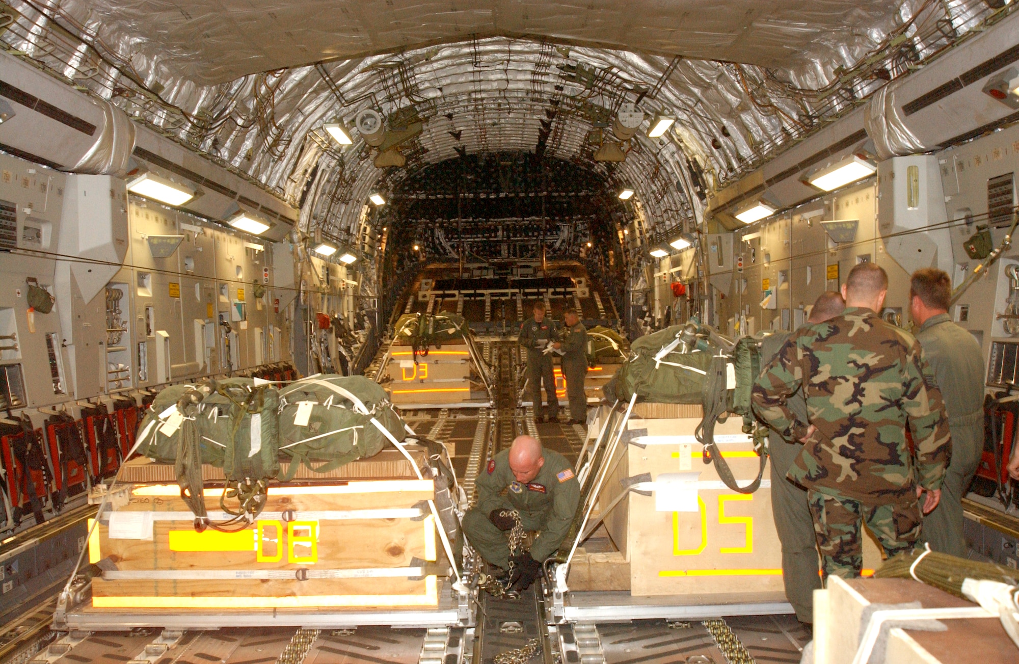 ALTUS AIR FORCE BASE, Okla. -- Loadmasters chain down cargo and make final checks on a C-17 Globemaster III on July 5 in preparation for a dual-row airdrop.  (U.S. Air Force photo by Airman 1st Class Aldric Borders)
