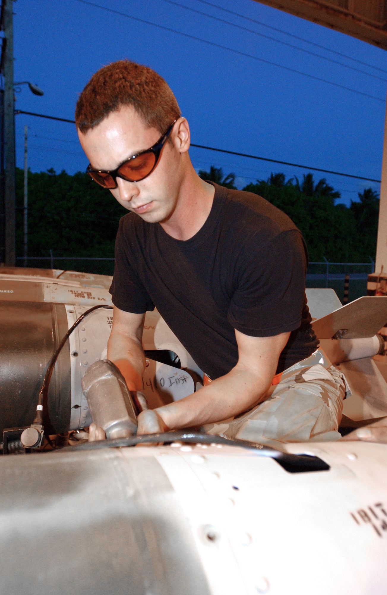 OPERATION ENDURING FREEDOM -- Airman 1st Class Christopher Stegman removes the fin kit of a joint-direct attack munition for cleaning during semiannual refurbishment at a forward-deployed location.  Airman Stegman is a munitions specialist with the 40th Expeditionary Maintenance Squadron and is deployed from Minot Air Force Base, N.D.  (U.S. Air Force photo by Staff Sgt. Jocelyn Rich)