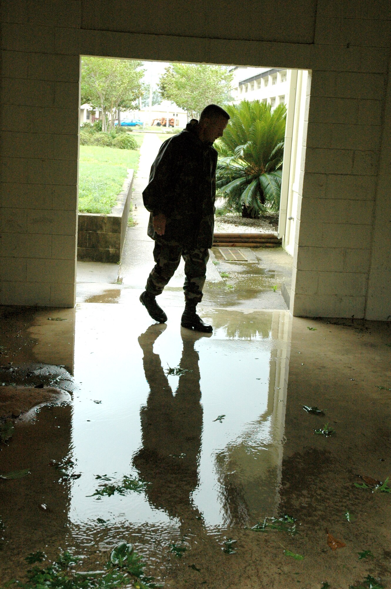 EGLIN AIR FORCE BASE, Fla. -- Chief Master Sgt. Wade Johnson looks over water damage to the enlisted professional development center and neighboring dormitories caused by Hurricane Dennis on July 10.  Unlike Hurricane Ivan, Hurricane Dennis did not cause as much damage to the base.  Chief Johnson is the 96th Air Base Wing command chief master sergeant.  (U.S. Air Force photo by Senior Airman Mike Meares)