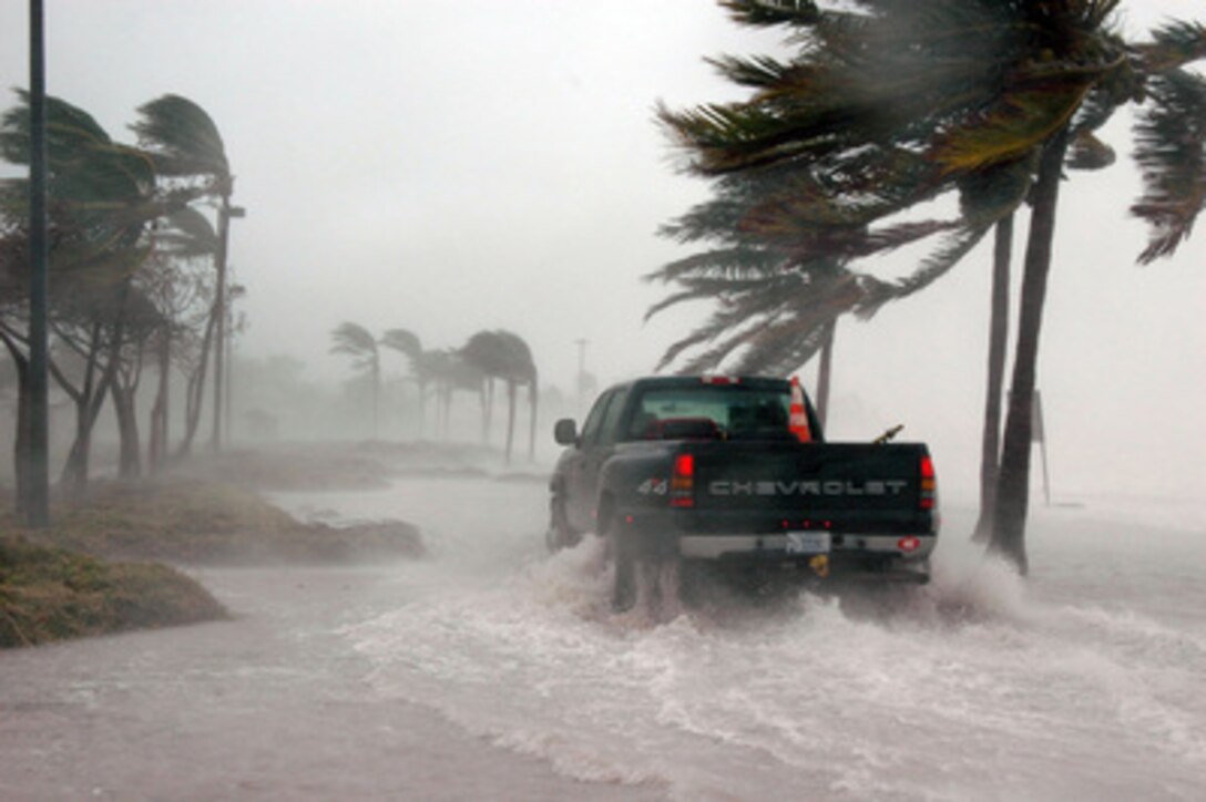 A Navy security team eases their way through water and debris at the Truman Annex of Naval Air Station Key West, Fla., as Hurricane Dennis passes the southernmost tip of the base on July 9, 2005. The storm passed within 125 miles of the base, clocking winds in excess of 90 miles an hour and dumping more than seven inches of rain before moving north through the Gulf of Mexico. 