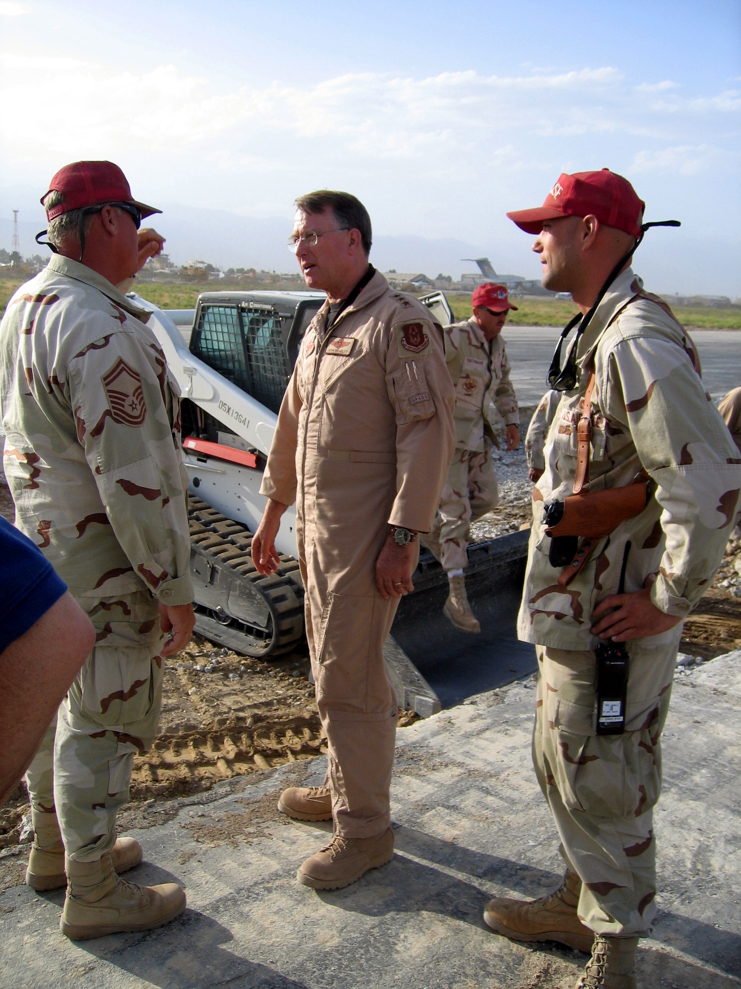 AFGHANISTAN -- Lt. Gen. John A. Bradley (center), commander of Air Force Reserve Command, chats with reservists from a Red Horse unit deployed here to repair runways.  (U.S. Air Force photo by Lt. Col. Anthony J. Seely)