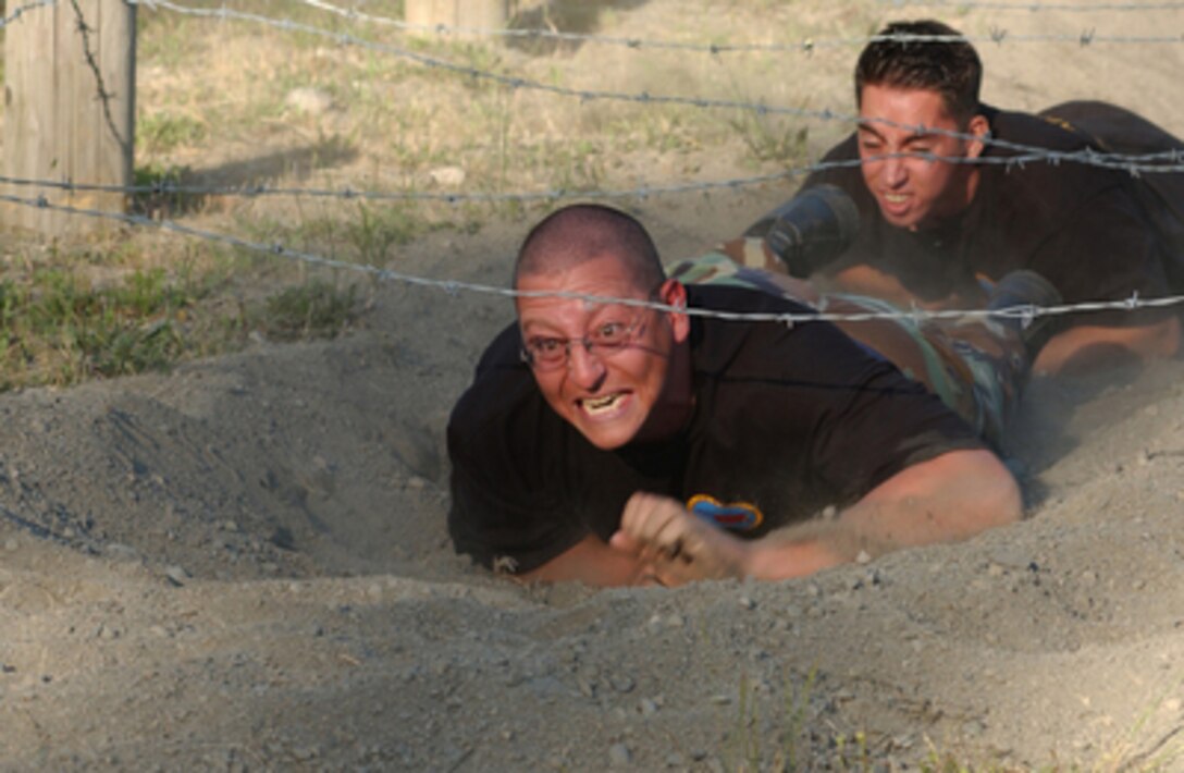 Air Force Staff Sgt. Kevin Taboada is all about determination as he speeds through the trenches of the confidence course during the Air Mobility Rodeo competition at McChord Air Force Base, Wash., on June 23, 2005. Taboada is deployed to McChord for the competition from Altus Air Force Base, Okla. 