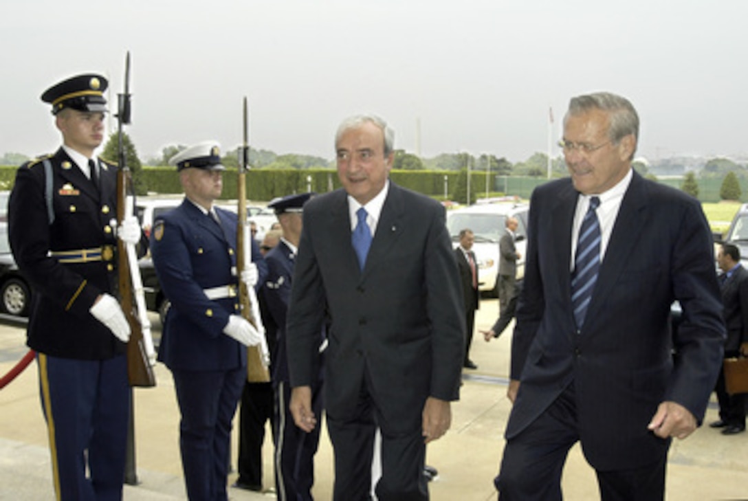 Secretary of Defense Donald H. Rumsfeld (right) escorts Italian Minister of Defense Antonio Martino (left) through an honor cordon and into the Pentagon on July 12, 2005. Rumsfeld and Martino will meet to discuss a range of bilateral security issues. 
