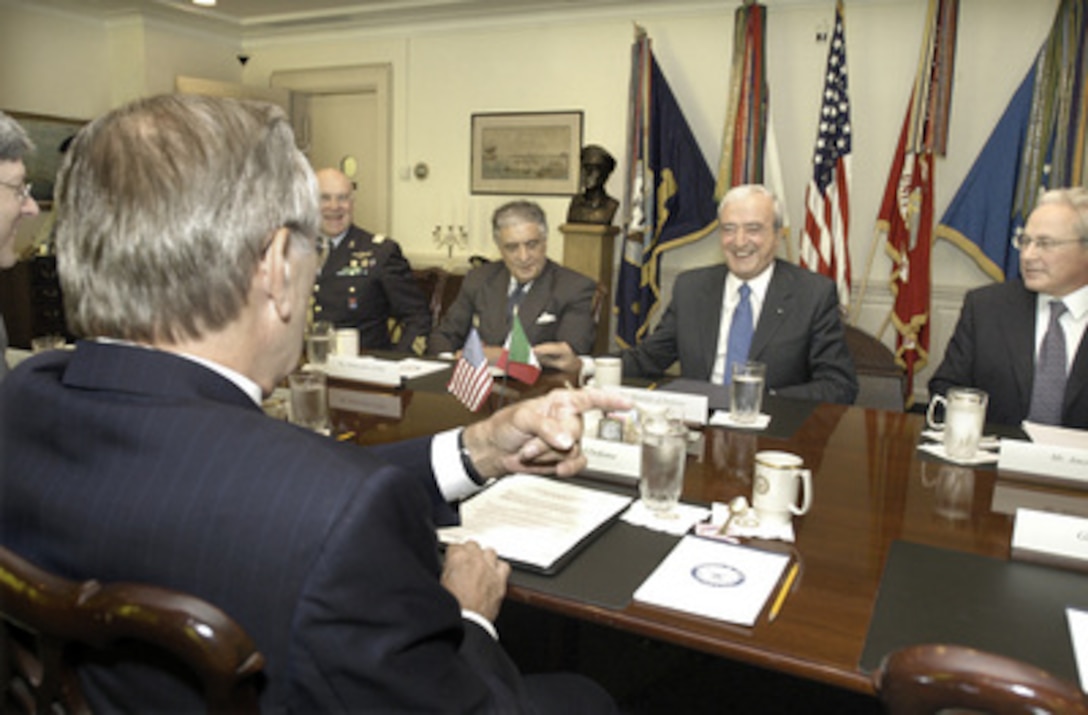 Italian Minister of Defense Antonio Martino (2nd from right) and Secretary of Defense Donald H. Rumsfeld (foreground) share some light conversation at the start of their bilateral security discussions in the Pentagon on July 12, 2005. Members of the Italian delegation included (left to right) Italian Embassy Defense Attaché Maj. Gen. Pasquale Preiosa, Ambassador Sergio Vento, Martino and Advisor to the Minister of Defense Acquille Amerio. 