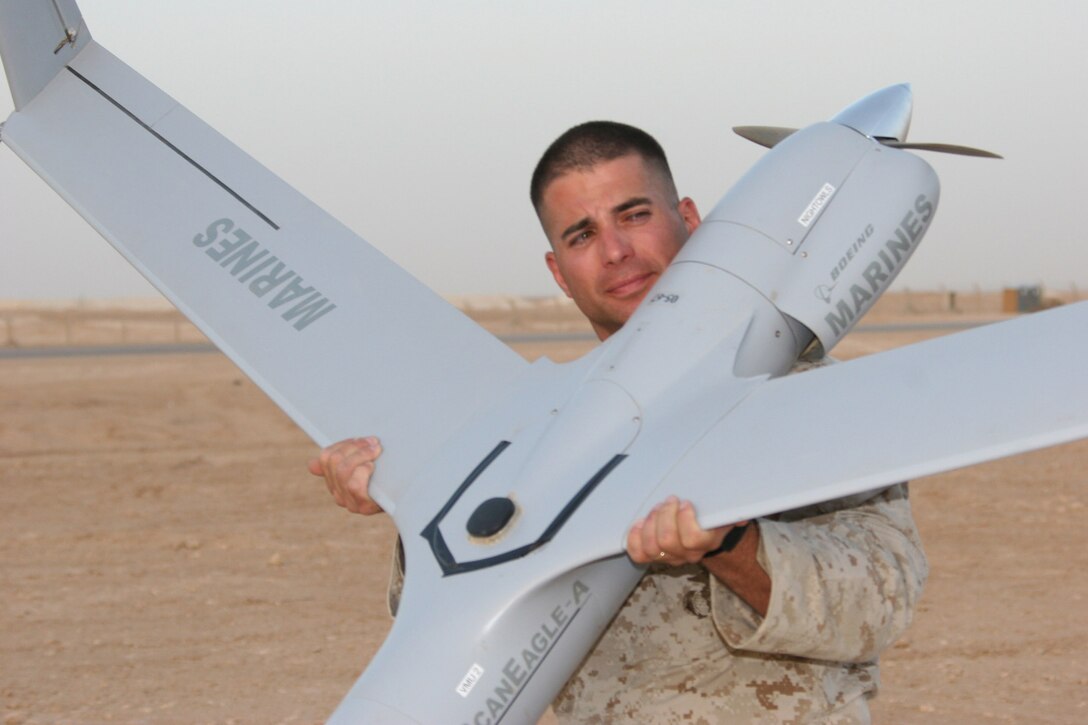 AL ASAD, Iraq ? Staff Sgt. Jose Gonzalez, the staff noncommissioned officer-in-charge of the ScanEagle detachment with Marine Unmanned Aerial Vehicle Squadron 2 transports one of the ScanEagle unmanned aerial vehicles after landing here July 14. Gonzalez is a 1990 graduate of Miami Springs Senior High School in Miami Springs, Fla.