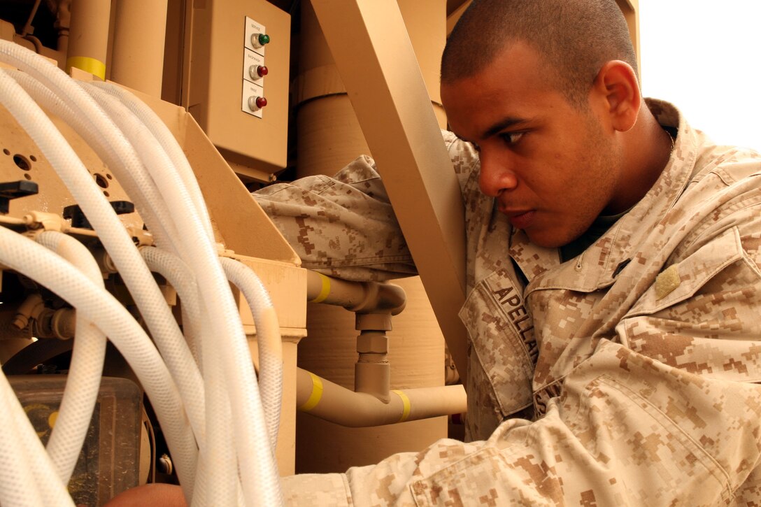 CAMP GANNON, Iraq (May 17, 2007) ? Cpl. Christian Appellaniz, a water treatment specialist here, makes adjustments to a chemical feed pump, which purifies water. Appellaniz, a Queens, N.Y., native, is one of a few 2nd Marine Logistics Group (Forward) Marines serving at Camp Gannon to support efforts to stabilize Iraq.