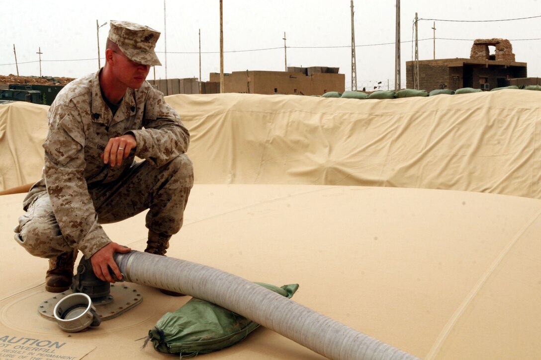 CAMP GANNON, Iraq (May 17, 2007) ? Sgt. Jason R. Long, the fuel farm NCOIC here, inspects the equipment on his fuel farm to ensure no fuel is being leaked. Long and the other 2nd MLG (Fwd) Marines here provide services to support the Marines of 1st Battalion, 4th Marines. Long, a Marshalltown, Iowa, native, is on his third deployment, but his first to Iraq.