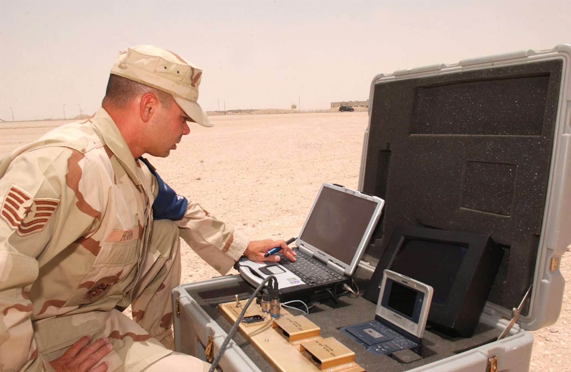 SOUTHWEST ASIA -- Tech. Sgt. Christopher Hearn monitors the progress of a force protection airborne surveillance system vehicle as it performs reconnaissance in Southwest Asia.  He is assigned to the 379th Expeditionary Security Forces Squadron at a forward-deployed location and is from Elmendorf Air Force Base, Alaska.  (U.S. Air Force photo by Tech. Sgt. Randy Mallard)