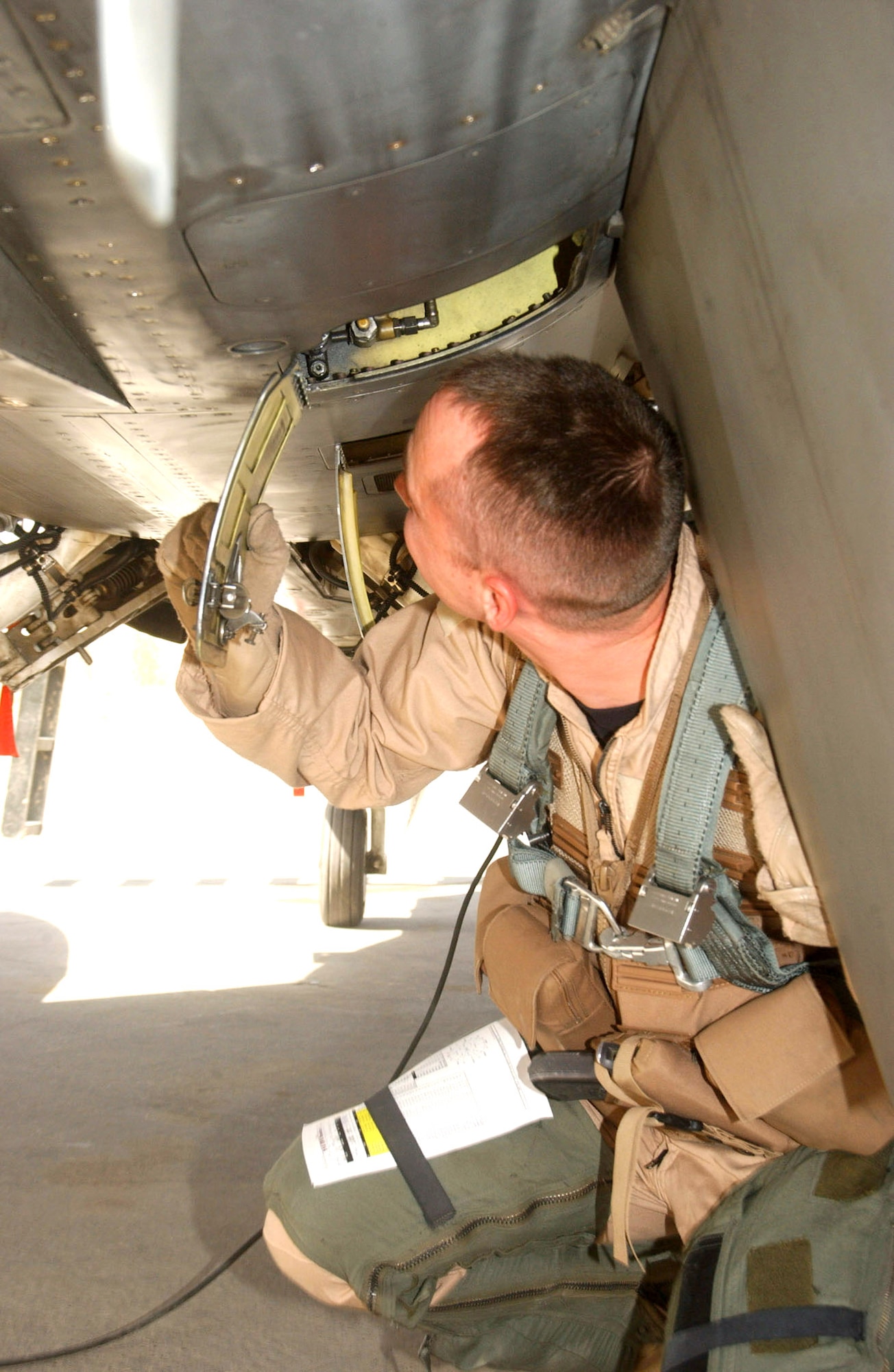 BALAD AIR BASE, Iraq -- First Lt. Christopher Jones completes an inspection of his aircraft before departure.  Pilots work alongside maintainers to ensure each mission goes off without a hitch.  Using the training they receive at their home stations, pilots are using their weapons systems to provide convoy escort, raid support and infrastructure reconnaissance for troops on the ground.  Lieutenant Jones is an F-16 Fighting Falcon pilot with the 510th Expeditionary Fighter Squadron.  (U.S. Air Force photo by Senior Airman Shaun Emery)