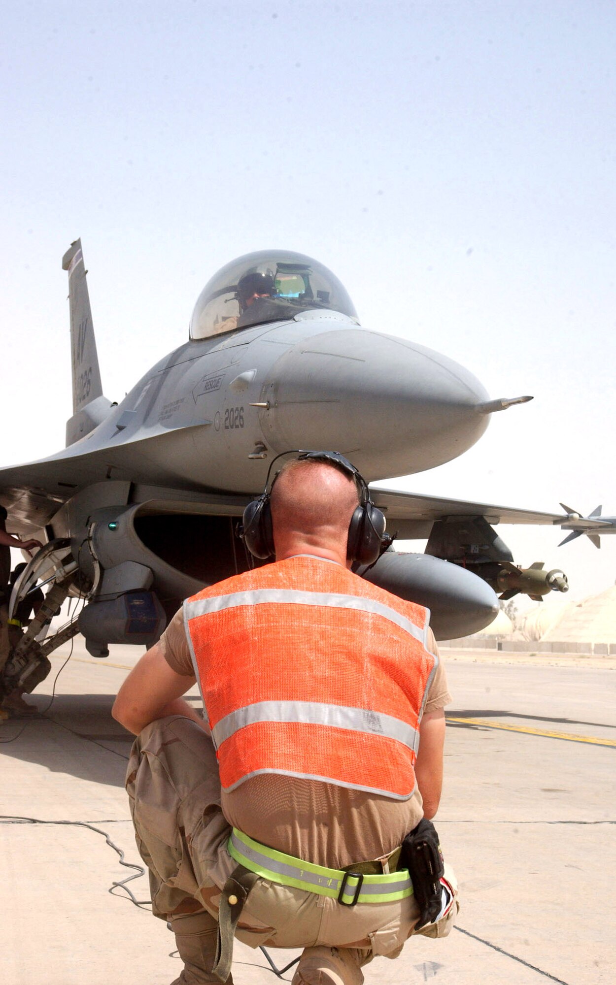 BALAD AIR BASE, Iraq -- An F-16 Fighting Falcon pilot and crew chief go through a final inspection before taking off from here.  Aircrews from the 332nd Air Expeditionary Wing provide close-air support to troops on the ground.  (U.S. Air Force photo by Senior Airman Shaun Emery)    