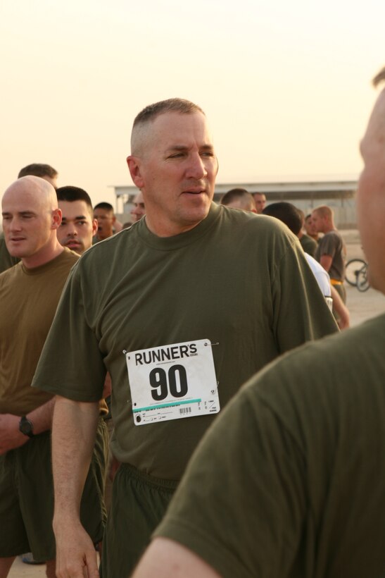 AL TAQADDUM, Iraq (May 19, 2007) ? Lt. Cmdr. Patrick J. McLaughlin observes his competition prior to beginning a five-kilometer run to benefit servicemembers who sustained injuries while deployed oversees. Prior to the event, McLaughlin, the chaplain of 2nd MLG (Fwd), led more than 600 servicemembers in prayer.