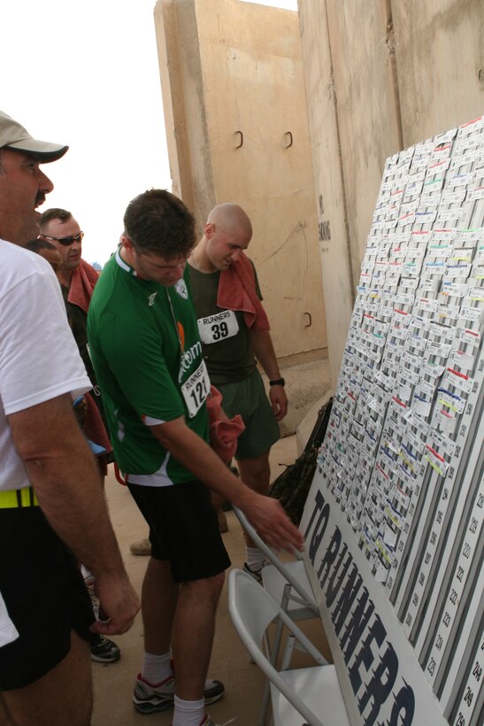 AL TAQADDUM, Iraq (May 19, 2007) ? After completing a five-kilometer run, participants in the stations ?Run for the Warriors? check the race results. Other than a total of 1,200 shirts provided to the many participants, the runners walked away with the satisfaction of raising more than $26,000 to benefit those who concluded their deployment sooner than expected after sustaining injuries.