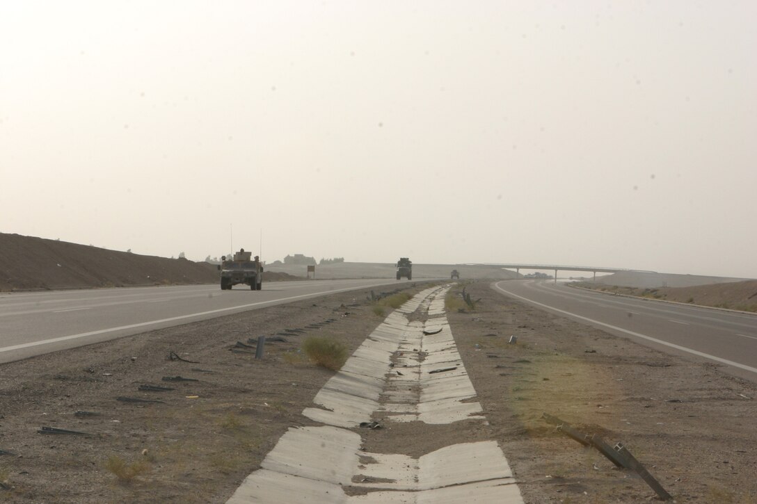 CAMP FALLUJAH, Iraq – The gun trucks of the Marines with Military Police Detachment, Combat Logistics Battalion 8, 2d Force Service Support Group (Forward), cruise the roadways of the Fallujah area; the Marines inside searching for any sign of insurgent activity. The detachment assists 1st Bn., 6th Marine Regiment, Regimental Combat Team 8, 2nd Marine Division, in ensure the roadways remain free of insurgent activity to allow safe passage for Coalition Forces. (Photo by Cpl. John E. Lawson Jr.)