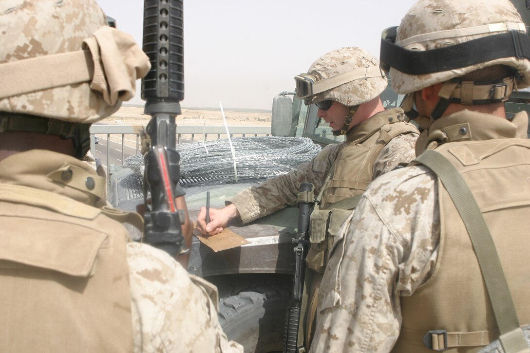 CAMP FALLUJAH, Iraq – Staff Sgt. Lance Jamie M. Lybrand, patrol leader and platoon sergeant for the Military Police Detachment, Combat Logistics Battalion 8, 2d Force Service Support Group (Forward), plans and briefs his Marines on setting up a vehicle checkpoint while patrolling major roadways in the Fallujah area. The MPs conduct security patrols and VCPs along certain major roadways to eliminate the insurgent threat and ensure safe passage for Coalition Forces. (Photo by Cpl. John E. Lawson Jr.)