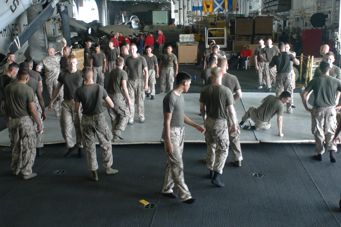 Marines of Battalion Landing Team, 2nd Bn., 8th Marines, practice their martial arts skills July 18 aboard the amphibious assault ship USS Kearsarge (LHD 3) in preparation for the gray belt advancement test in the Marine Corps Martial Arts Program.  The BLT Marines are serving as the ground combat element for the 26th Marine Expeditionary Unit (Special Operations Capable) currently conducting distributed operations in the central command area of responsibility.  (Official USMC photo by Gunnery Sgt. Mark E. Bradley) (Released)