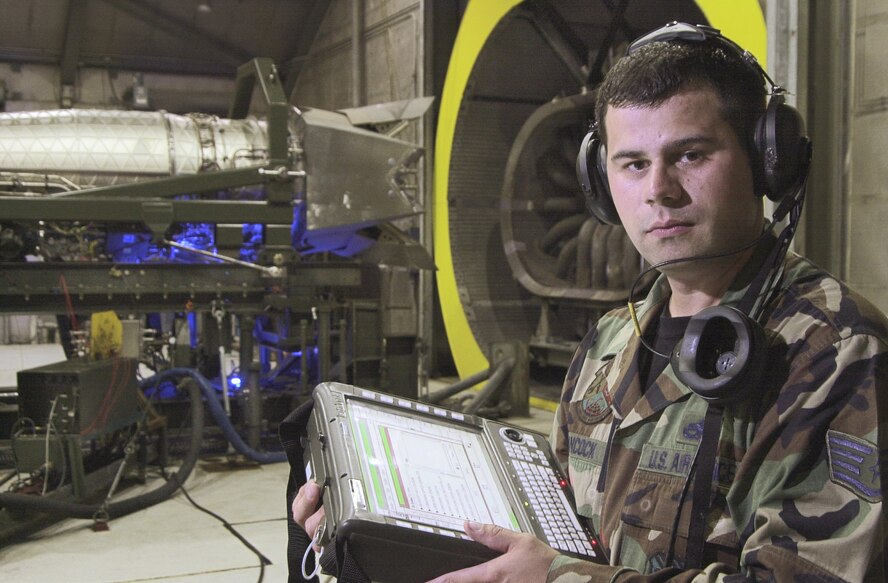 LANGLEY AIR FORCE BASE, Va. -- Staff Sgt. William Hancock uses a portable maintenance aid in preparation of a nozzle vector test of an F/A-22 Raptor engine July 15.  Airmen with the 1st Component Maintenance Squadron here are going through classes and training to certify them on the new engine.  (U.S. Air Force photo by Staff Sgt. Tanika Bell)