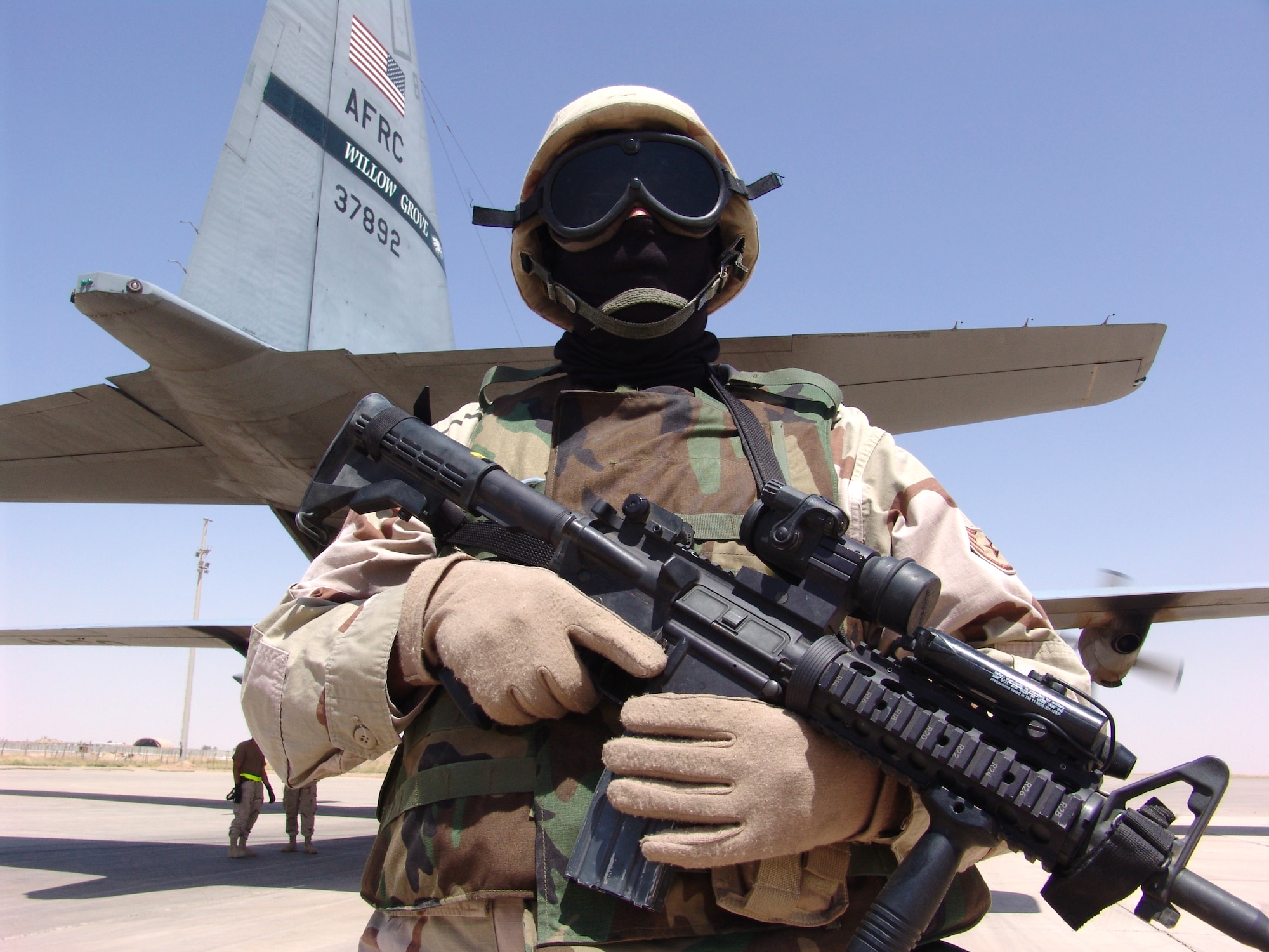 SOUTHWEST ASIA -- Staff Sgt. Leslie Poling guards a C-130 Hercules and crew after arriving at Kirkuk Air Base, Iraq. Security Forces' Ravens are flyaway security forces teams that protect aircraft and aircrews while airborne and on the ground.  Sergeant Poling is assigned to the 386th Expeditionary Security Forces Squadron and is deployed from Royal Air Force Lakenheath, England.  (U.S. Air Force photo by Master Sgt. Al Gerloff)