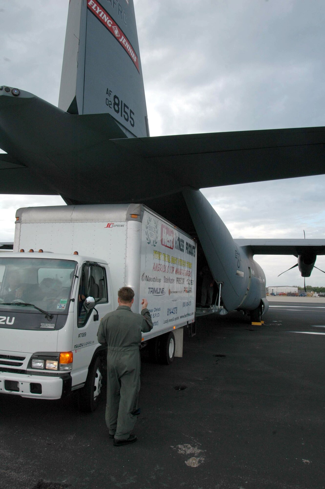 CORPUS CHRISTI, Texas -- Senior Master Sgt. Todd Patterson guides a truck carrying Noah, a rescued dolphin, under the tail of a C-130J Hercules used to transport him to Florida.  Sergeant Patterson is a loadmaster with the 815th Airlift Squadron at Keesler Air Force Base, Miss.  (U.S. Air Force photo by Tech. Sgt. James B. Pritchett)