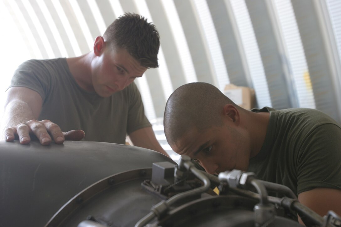 AL TAQADDUM, Iraq ? Sergeant Ryan Bogedin, a Westland, Mich., native, and Lance Cpl. Edgar Lugo, a Goshen, N.Y., native, both flightline mechanics on Marine Medium Helicopter Squadron 364?s phase crew, put an engine together after inspecting it as part of a 150-hour phase inspection. The phase crew has completed 21 phase inspections since their arrival in March.
