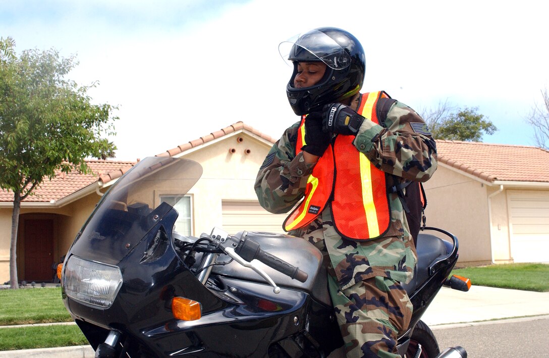 VANDENBERG AIR FORCE BASE, Calif. -- Staff Sgt. Allen Puckett fastens the chin strap of his helmet.  Proper wear of safety equipment is an essential element of reducing risk while riding motorcycles.  (U.S. Air Force photo by Staff Sgt. Orly Tyrell)