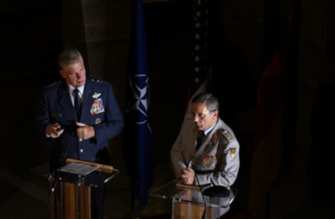 Chairman of the Joint Chiefs of Staff Gen. Richard B. Myers (left) and his German counterpart Gen. Wolfgang Schneiderhan take questions from the German media during a press conference at the Federal Ministry Building in Berlin, Germany, on July 18, 2005. Myers is in Berlin to discuss current military-to-military relations between the two NATO allies. 