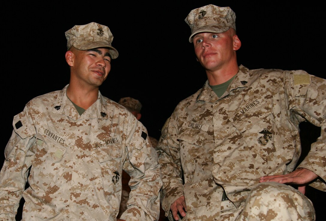 Sgt. Nicholas K. Cervantes, communications chief, A Company, 8th Communication Battalion, and Sgt. Robert M. Childree, operations noncommissioned officer, A Co., reflect on their impending deployment while staging their gear. A contingent of 8th Comm. Bn. Marines deployed to Iraq July 18 as an advance party to prepare for the arrival of the main body.