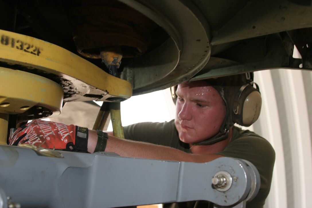 AL TAQADDUM, Iraq ? Private first class Timothy Wade, a flightline mechanic with Marine Medium Helicopter Squadron 364 and Wortham, Texas, native, checks the tubing on a CH-46E. The phase crew is comprised of five Marines who are responsible for the regularly scheduled maintenance for all of their aircraft here.