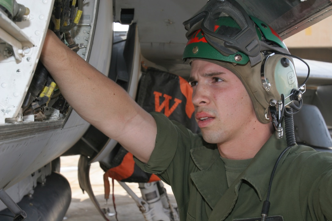 AL ASAD, Iraq?Lance Cpl. Matthew A. Wagner, avionics technician and native of Fort Smith, Ark., checks various instruments that allow the F/A-18 Hornet?s computer stay in sync with other components on the jet.  Wagner joined the Marine Corps at the end of 2003 and has been deployed here for almost seven months with Marine All-Weather Fighter Attack Squadron 224.