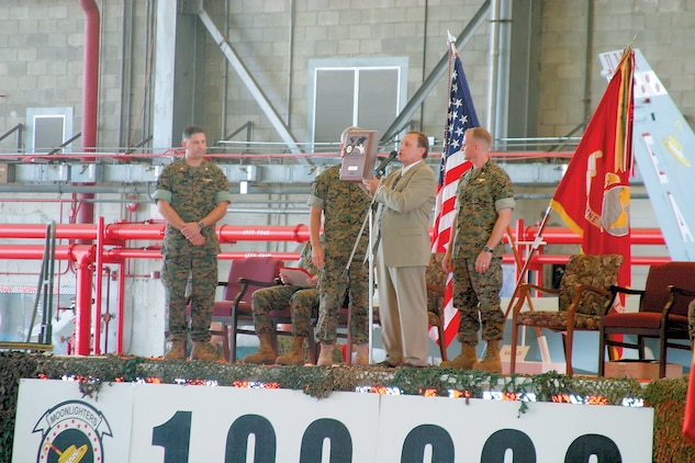 Gary Van Gysel, the head of Marine Field Offices East Coast for Boeing Company, presents Marine All-Weather Fighter Attack Squadron 332 with a plaque during a ceremony held at the squadron hangar aboard the Air Station, July 20, for completing 100,000 mishap-free hours.