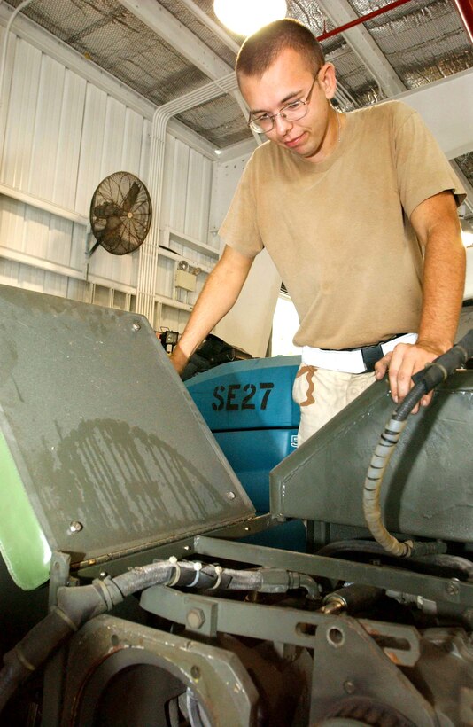 OPERATION ENDURING FREEDOM -- Airman 1st Class Jerred Goodroad inspects a bomb-lift vehicle scheduled for an engine swap at a forward-deployed location.  He is an aerospace ground equipment mechanic with the 40th Expeditionary Maintenance Squadron deployed from Minot Air Force Base, N.D.  (U.S. Air Force photo by Staff Sgt. Jocelyn Rich)