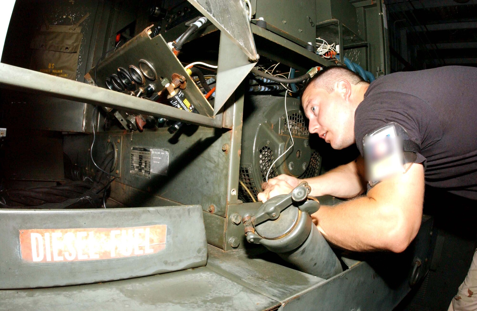 OPERATION ENDURING FREEDOM -- Staff Sgt. Michael Snow troubleshoots a fuel gauge malfunction on a Hobart-86 at a forward-deployed location.  He is an aerospace ground equipment mechanic with the 28th Expeditionary Air Refueling Squadron deployed from MacDill Air Force Base, Fla.  (Digitally altered U.S. Air Force photo by Staff Sgt. Jocelyn Rich)