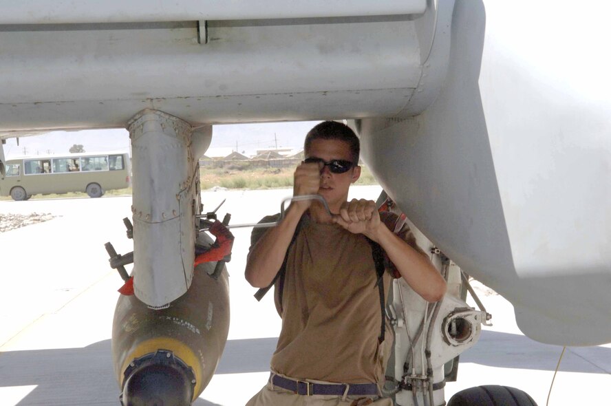 BAGRAM AIR BASE, Afghanistan -- Senior Airman Ver Ringais ensures a bomb is secure on an A-10 Thunderbolt II.  He is a weapons loader with the 455th Expeditionary Aircraft Maintenance Squadron here and is deployed from Pope Air Force Base, N.C.  (U.S. Air Force photo by Capt. Mark D. Gibson)
