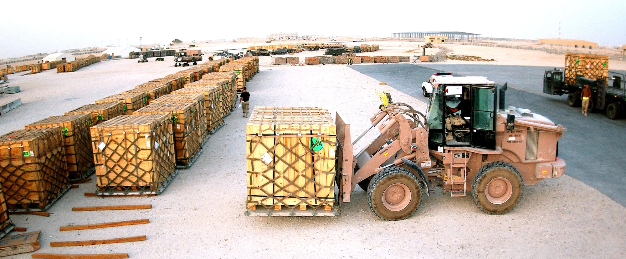 SOUTHWEST ASIA -- Airmen of the 8th Expeditionary Air Mobility Squadron at a forward-deployed location load pallets of up-armor kits July 19. The pallets will be flown to forward-deployed Soldiers and Marines.  (U.S. Air Force photo by Airman 1st Class Desiree Hayden)