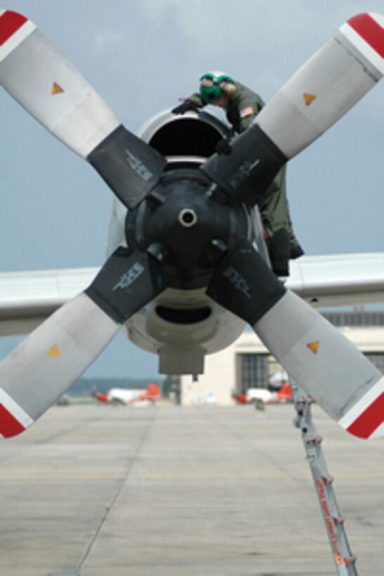 Navy Petty Officer 2nd Class Frank Wilson pre-flights one of the four engines of a P-3C Orion aircraft at Naval Air Station Jacksonville, Fla., before a training mission on July 11, 2005. Wilson is an aviation machinist's mate attached to Patrol Squadron 26 and is deployed to Jacksonville from U. S. Naval Air Station, Brunswick, Maine. 