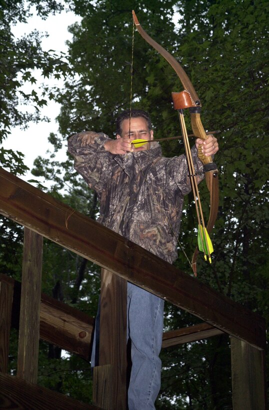 MARINE CORPS BASE CAMP LEJEUNE, N.C. - Carmen Lombardo, a wildlife biologist with the Camp Lejeune Environmental Conservation Branch and an avid bow hunter, holds before releasing an arrow off the tower at the Base Archery Range July 20. Archery season begins Sept. 10 and ends Oct. 7 for the state of North Carolina, but Camp Lejeune allows active service members, dependents, retired Marines and civilian base workers to hunt through Jan. 1. (Official Marine Corps photo by Lance Cpl. Matthew K. Hacker)