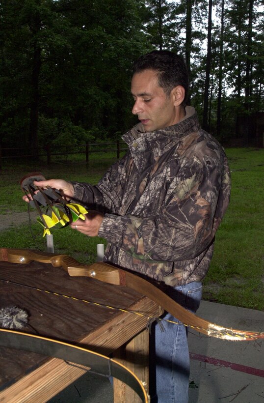 MARINE CORPS BASE CAMP LEJEUNE, N.C. - Carmen Lombardo, a wildlife biologist with the Camp Lejeune Environmental Conservation Branch and an avid bow hunter, assembles his re-curve bow system before firing at the Base Archery Range July 20. Archery season begins Sept. 10 and ends Oct. 7 for the state of North Carolina, but Camp Lejeune allows active service members, dependents, retired Marines and civilian base workers to hunt through Jan. 1. (Official Marine Corps photo by Lance Cpl. Matthew K. Hacker)