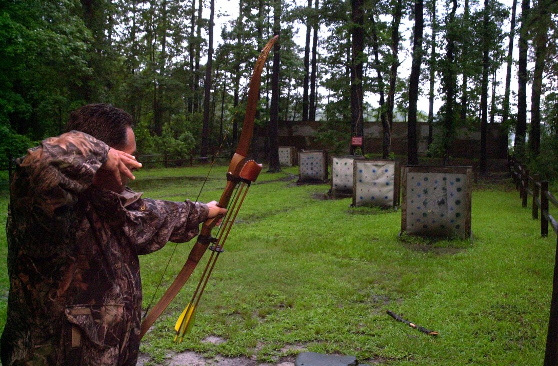 MARINE CORPS BASE CAMP LEJEUNE, N.C. - Carmen Lombardo, a wildlife biologist with the Camp Lejeune Environmental Conservation Branch and an avid bow hunter, releases an arrow at a target on the Base Archery Range July 20. Archery season begins Sept. 10 and ends Oct. 7 for the state of North Carolina, but Camp Lejeune allows active service members, dependents, retired Marines and civilian base workers to hunt through Jan. 1. (Official Marine Corps photo by Lance Cpl. Matthew K. Hacker)