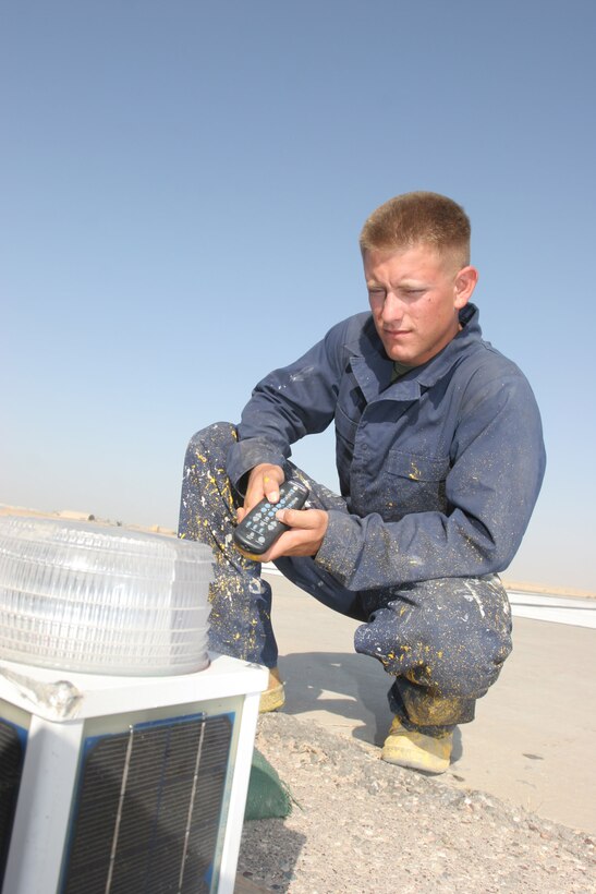 AL TAQADDUM, Iraq - Lance Cpl. Devin Walker, an expeditionary crewmember with Marine Wing Support Squadron 371 and Tulare, Calif., native, programs a light on the flightline here.