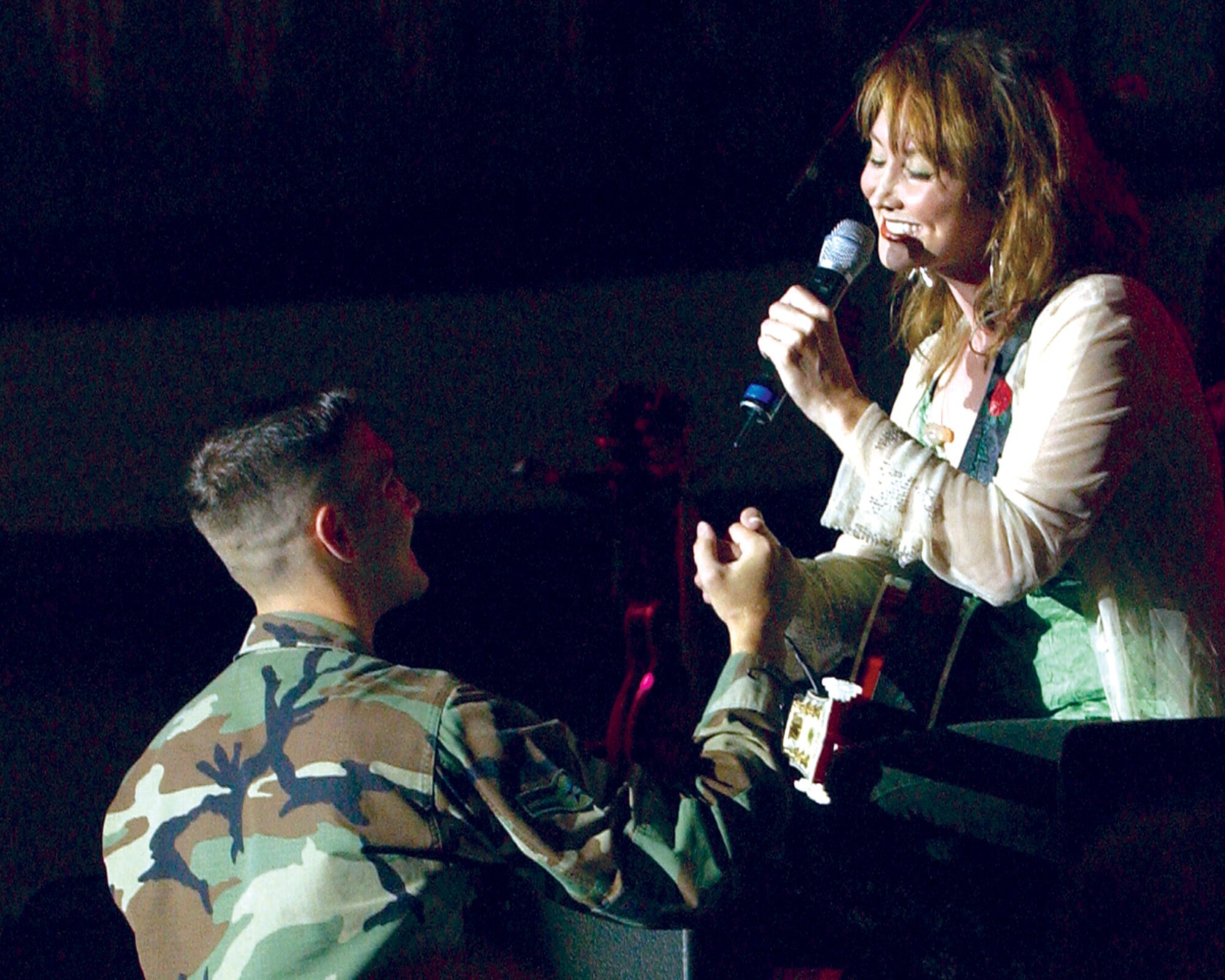 HOLLOMAN AIR FORCE BASE, N.M. -- Country music singer Pam Tillis sings to Airman 1st Class Brandon McDonald during a free concert here July 18. The concert is part of the Spirit of America Tour. (U.S. Air Force photo by Airman 1st Class Russell Scalf)